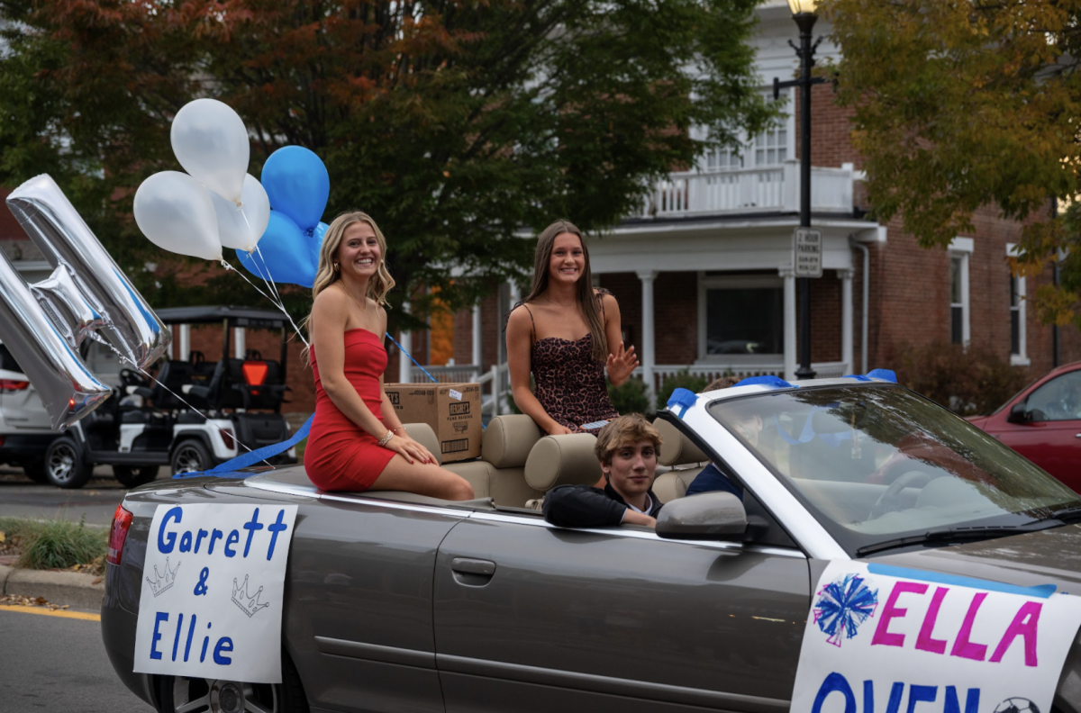 Ellie Mohr (12), Ella Cunningham (12), Garrett Wiggins (12), and Owen Yelton (12) drive a car in the parade. "My favorite part of the parade was passing out candy to all of the kids I know and seeing them smile," said Mohr. 